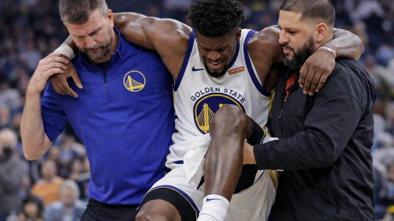 Jimmy Butler being helped off the court after a knee injury